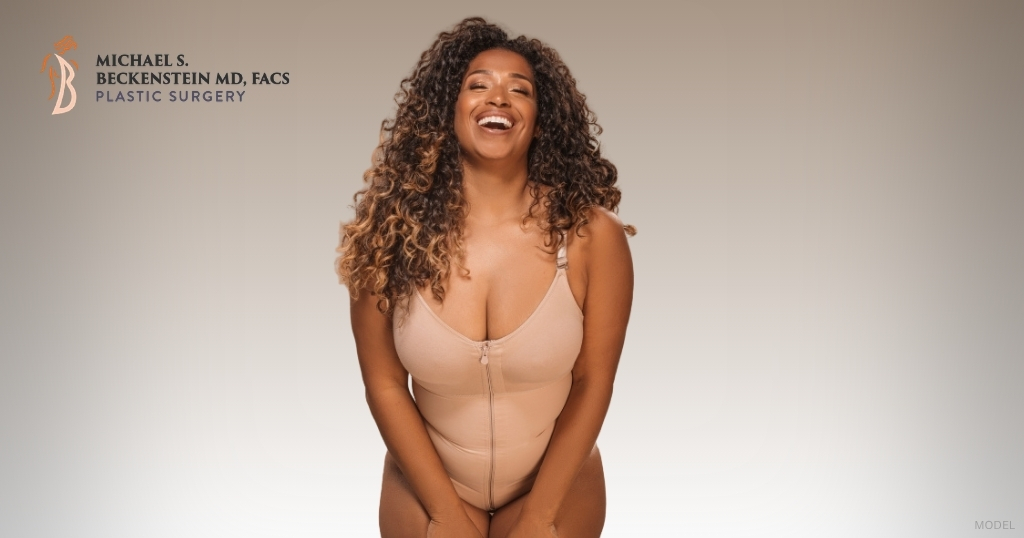Woman post tummy tuck procedure (model)
