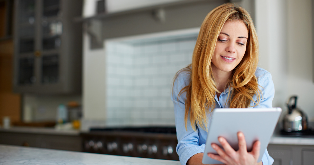 woman holding ipad in kitchen