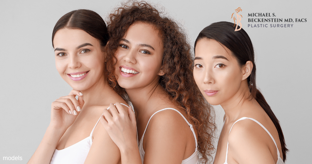 Three women standing together and smiling. (MODELS)